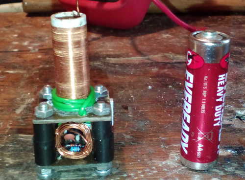 The device compared to a regular AA battery